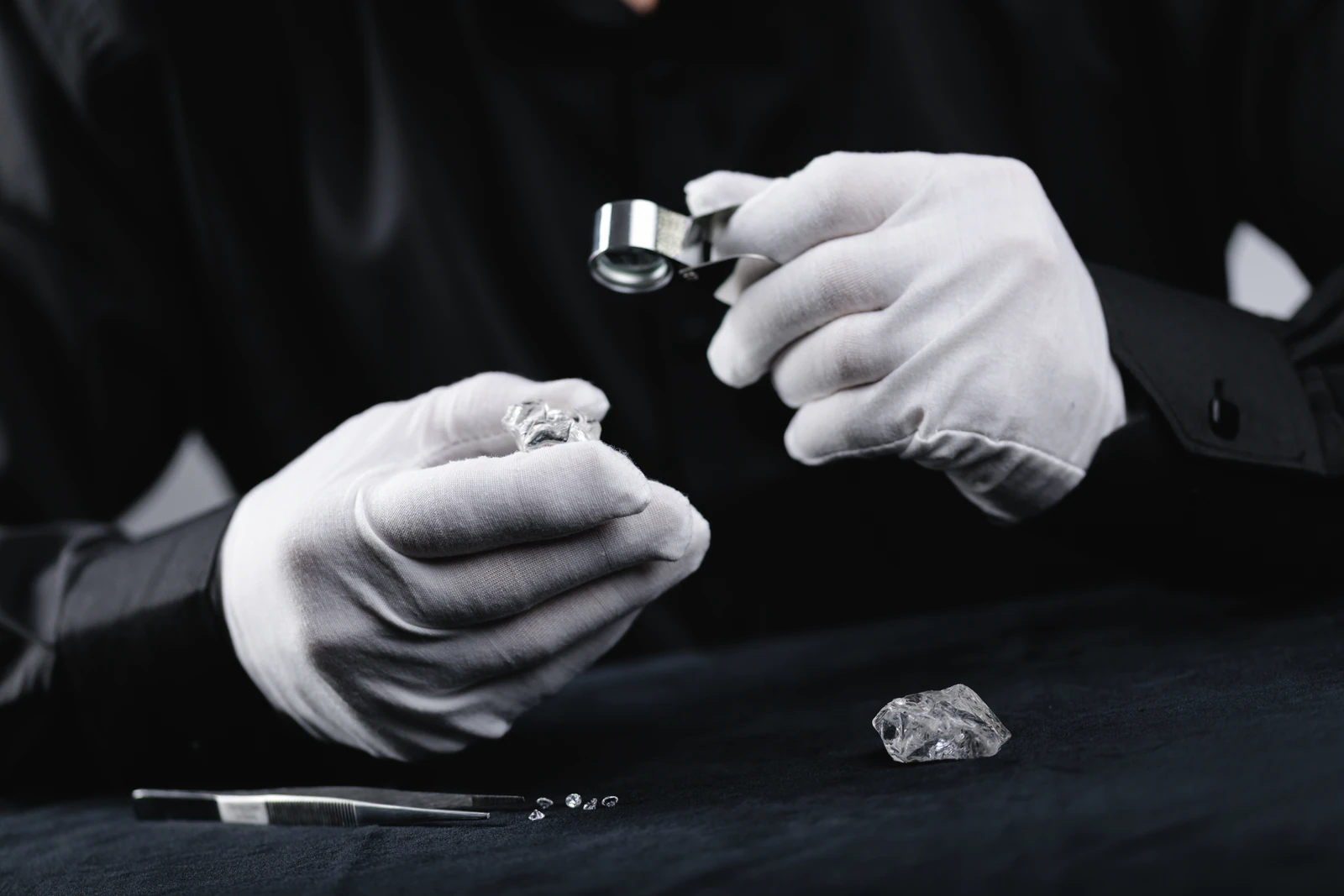 Gemologist examining a diamond with a loupe