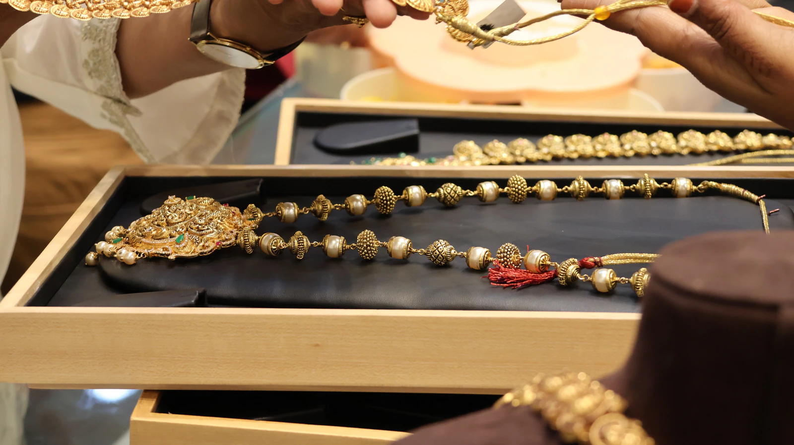Examining gold jewelry at a counter